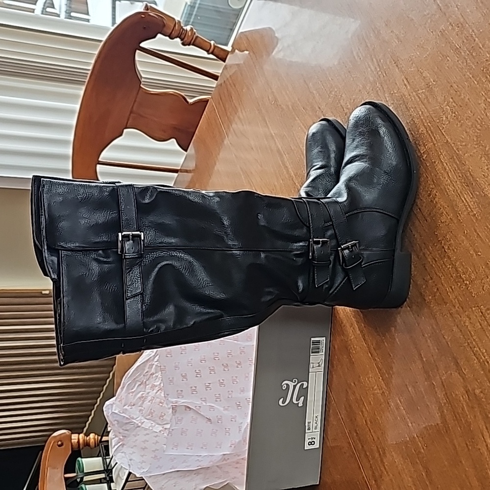 This is a pair of tall black, strappy boots size 8 1/2 Journee Collection BITE